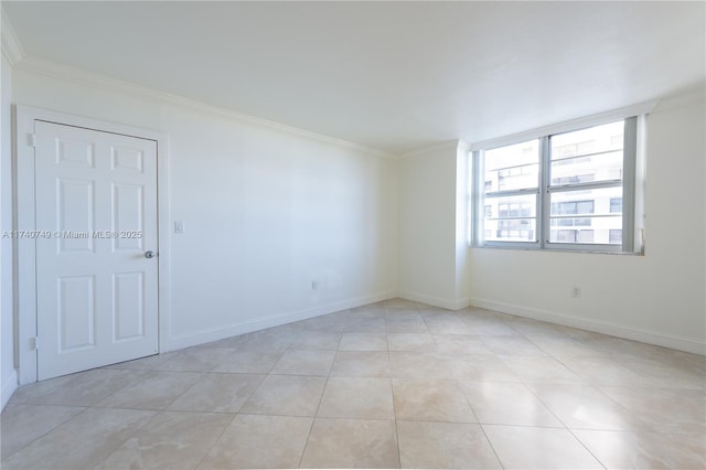 spare room with light tile patterned floors and crown molding