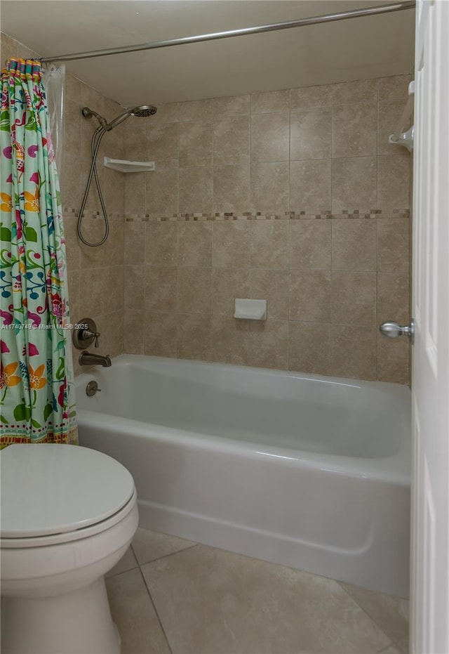 bathroom with tile patterned flooring, shower / tub combo, and toilet