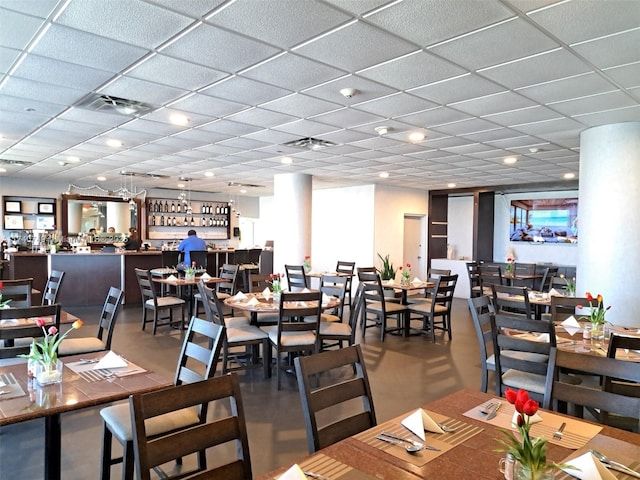 dining area featuring a drop ceiling