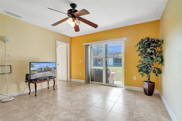 interior space with light tile patterned floors and ceiling fan