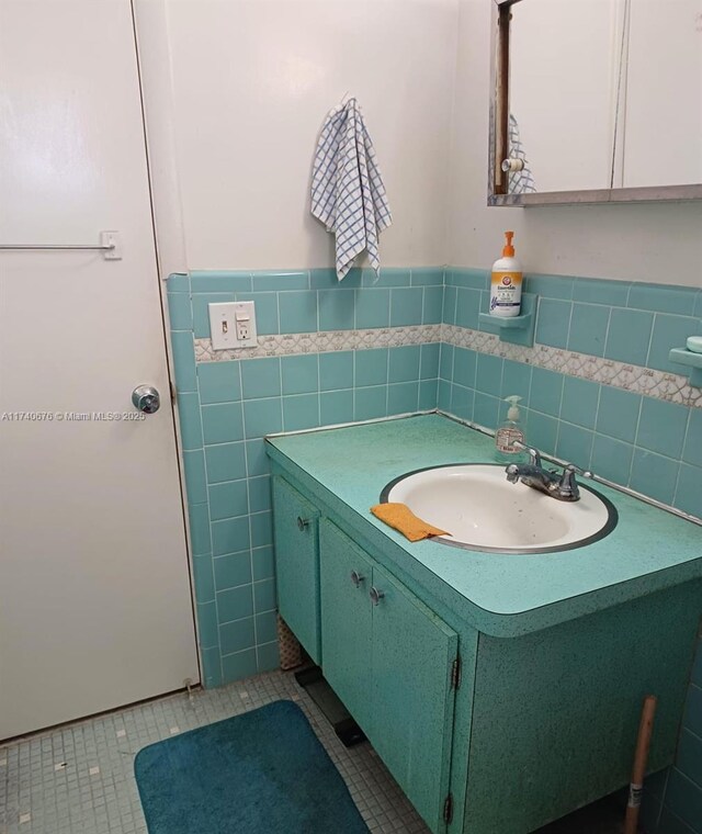 17090 NE 14th Ave Unit 314, Miami, FL 33162 - bathroom with tile patterned flooring, vanity, tile walls, and a wainscoted wall