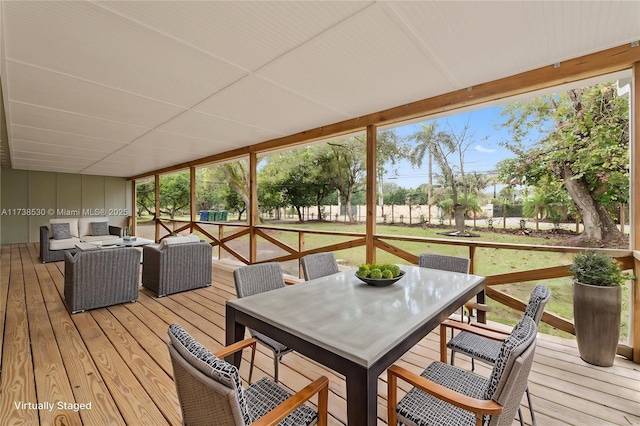 wooden terrace featuring an outdoor hangout area and a lawn