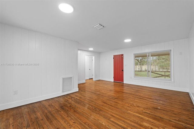 unfurnished room with wood-type flooring