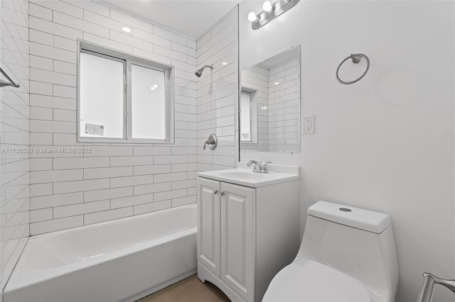 full bathroom with tiled shower / bath combo, vanity, and toilet