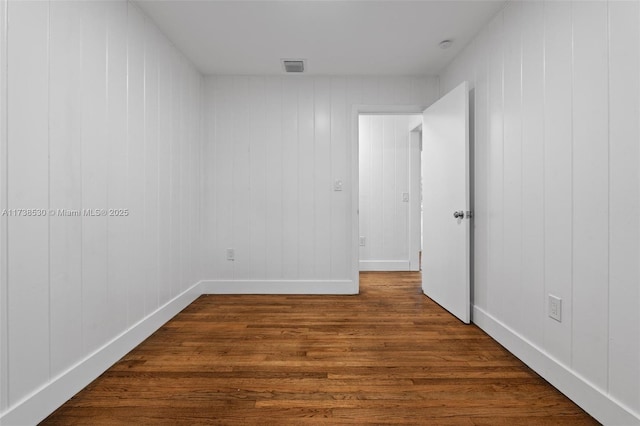 spare room featuring dark hardwood / wood-style flooring