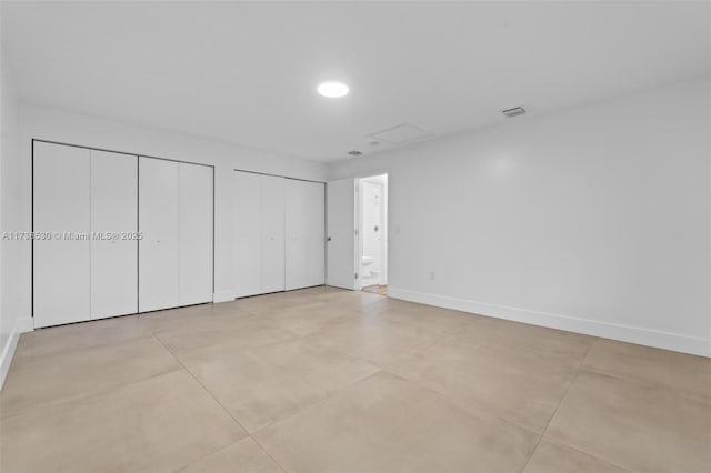 unfurnished bedroom with two closets