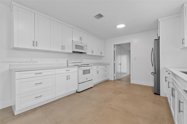 kitchen with white cabinets and white appliances