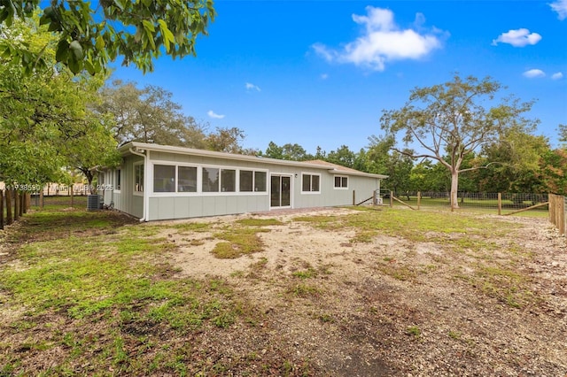 rear view of property with central AC unit