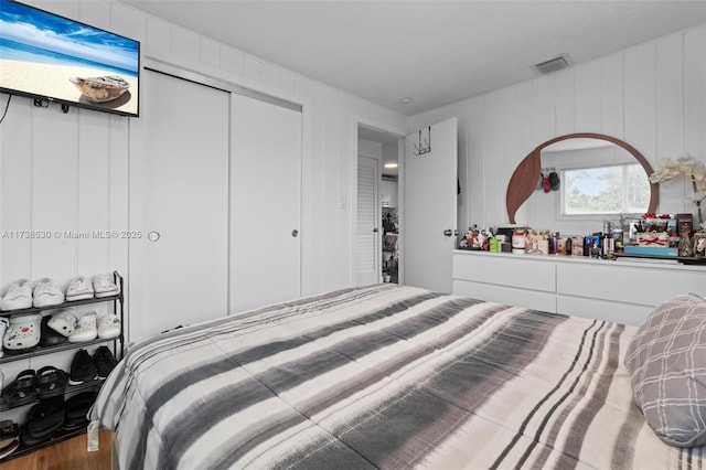 bedroom with hardwood / wood-style floors and a closet