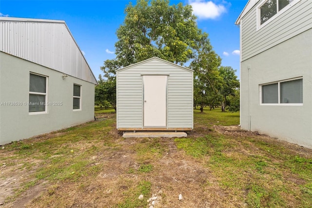 view of outbuilding featuring a lawn