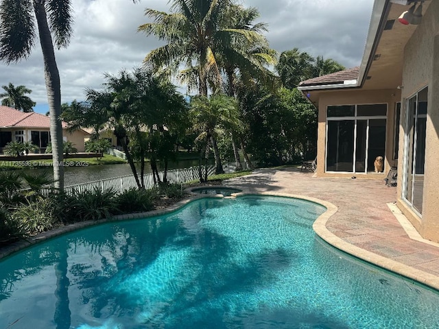 view of swimming pool featuring an in ground hot tub and a patio area