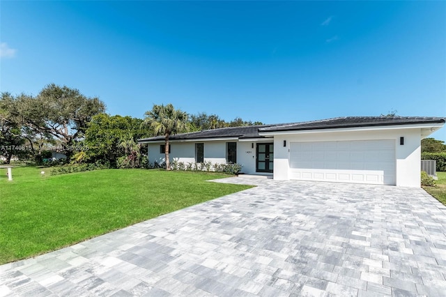 single story home with a front yard, cooling unit, and a garage