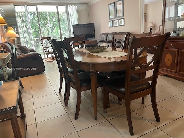 dining room with light tile patterned flooring, ornamental molding, and floor to ceiling windows