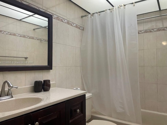 full bathroom featuring tasteful backsplash, tile walls, shower / bath combination with curtain, vanity, and toilet