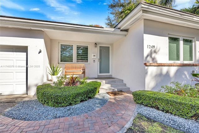 view of exterior entry with a garage