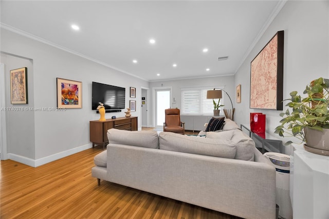 living room featuring crown molding and hardwood / wood-style floors