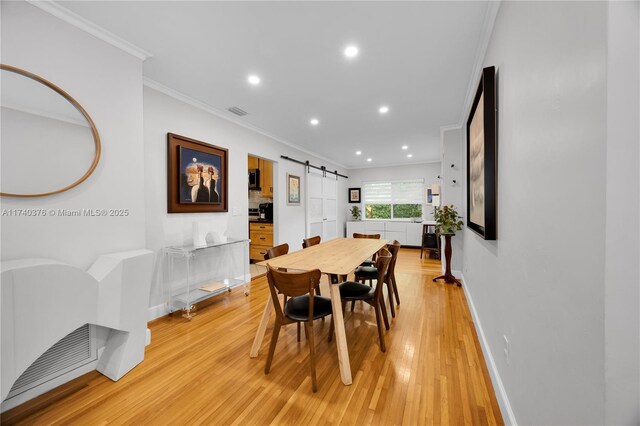 1249 Venetia Ave, Coral Gables, FL 33134 - dining room with light hardwood / wood-style floors, crown molding, and a barn door