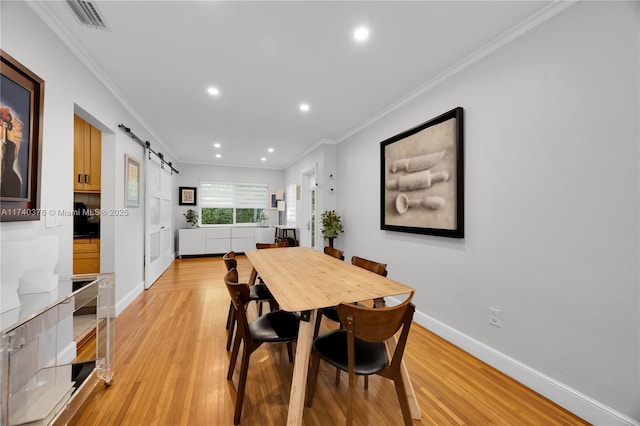 1249 Venetia Ave, Coral Gables, FL 33134 - dining space with crown molding, light hardwood / wood-style floors, and a barn door