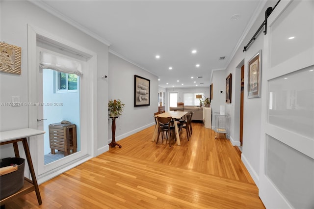 1249 Venetia Ave, Coral Gables, FL 33134 - dining space with a barn door, crown molding, and light hardwood / wood-style flooring