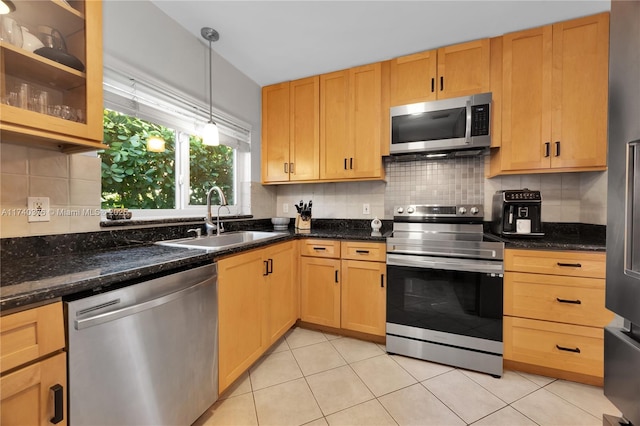 1249 Venetia Ave, Coral Gables, FL 33134 - kitchen featuring appliances with stainless steel finishes, sink, backsplash, dark stone counters, and hanging light fixtures