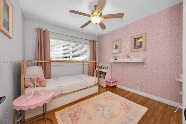 bedroom featuring hardwood / wood-style floors and ceiling fan