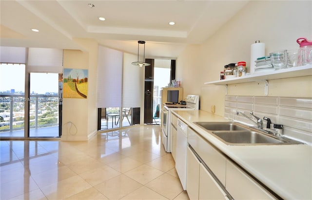4000 Island Blvd Unit 2402, Aventura, FL 33160 - kitchen featuring sink, white appliances, hanging light fixtures, backsplash, and white cabinets