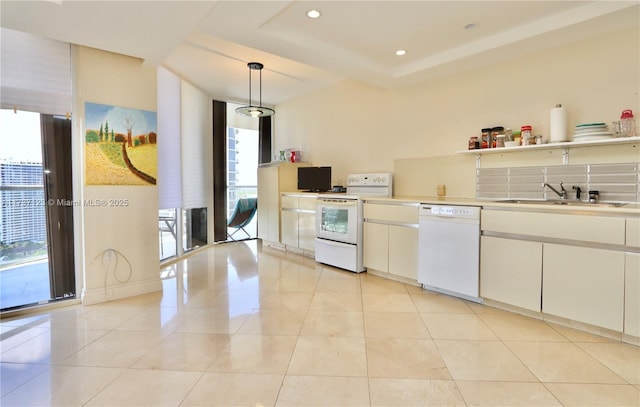 4000 Island Blvd Unit 2402, Aventura, FL 33160 - kitchen featuring sink, white appliances, white cabinetry, hanging light fixtures, and light tile patterned flooring