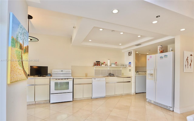 4000 Island Blvd Unit 2402, Aventura, FL 33160 - kitchen featuring white cabinetry, washer / clothes dryer, white appliances, and a raised ceiling