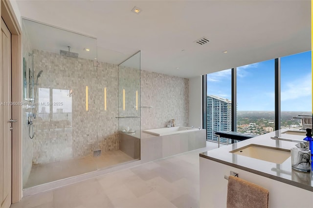 68 SE 6th St Unit 3911, Miami, FL 33131 - bathroom featuring vanity and independent shower and bath