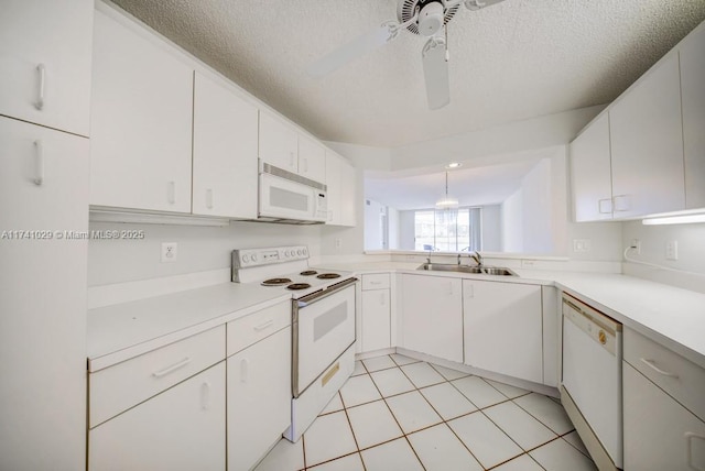 kitchen with white appliances, sink, and white cabinets