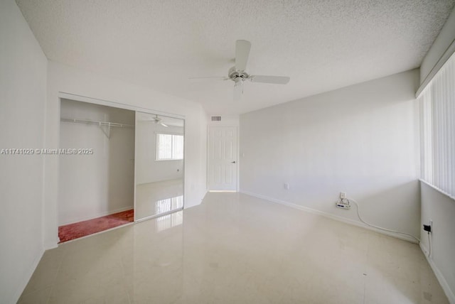 unfurnished bedroom featuring ceiling fan, a closet, and a textured ceiling