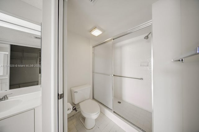 bathroom featuring toilet, vanity, and walk in shower