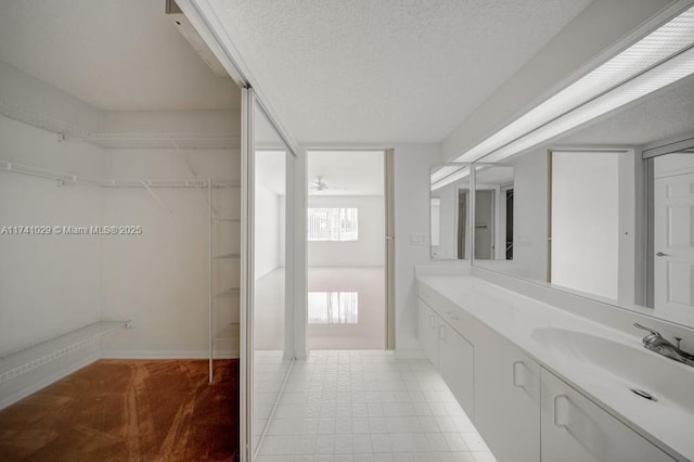 bathroom featuring tile patterned floors, vanity, and a textured ceiling