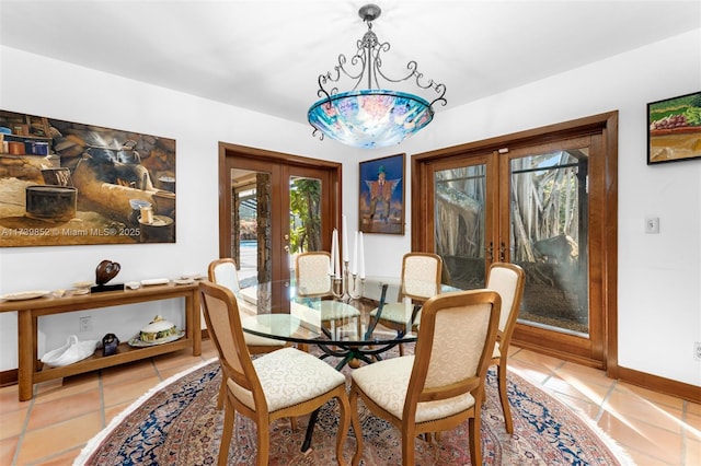 dining area with light tile patterned floors, a notable chandelier, and french doors