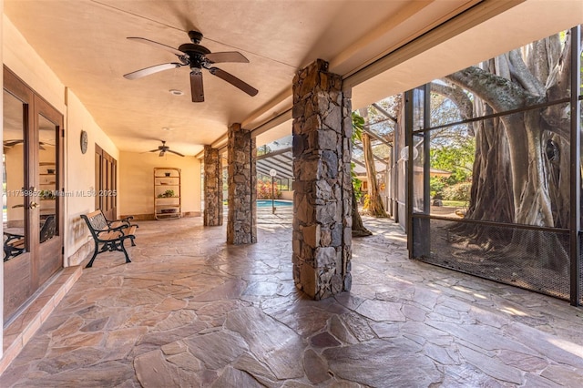 view of patio / terrace featuring ceiling fan and a lanai