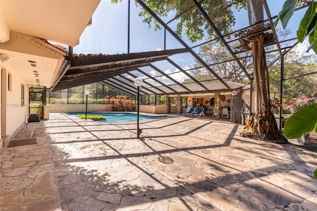 view of pool with a lanai and a patio