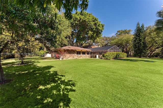 view of yard featuring glass enclosure