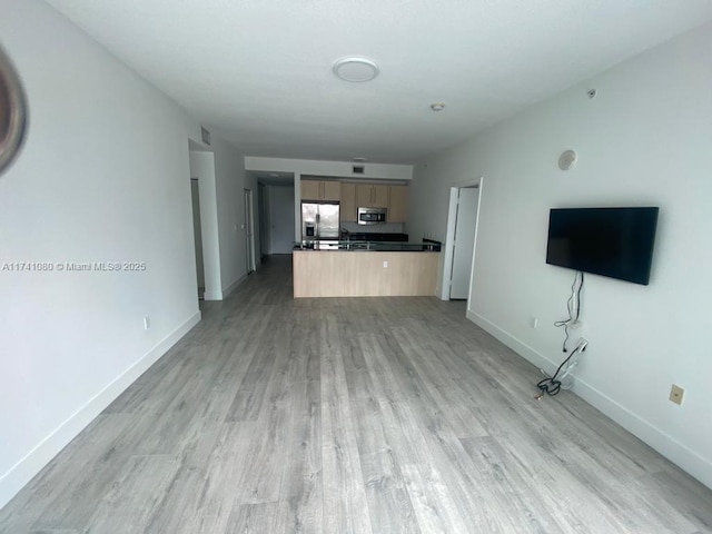 unfurnished living room with light wood-type flooring