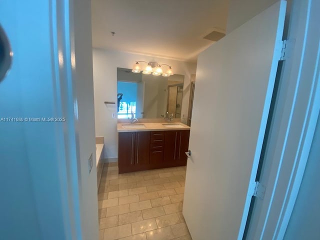 bathroom with tile patterned flooring, vanity, and a tub to relax in