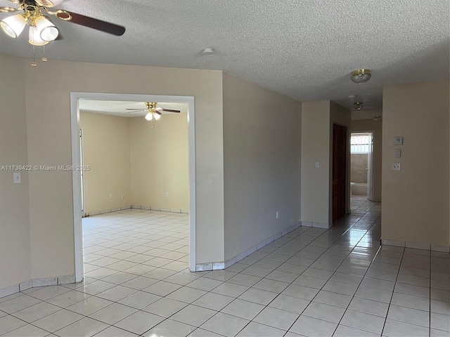 spare room with light tile patterned flooring and a textured ceiling