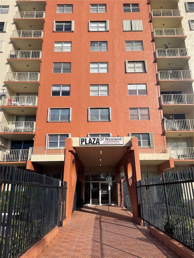 view of building exterior with fence