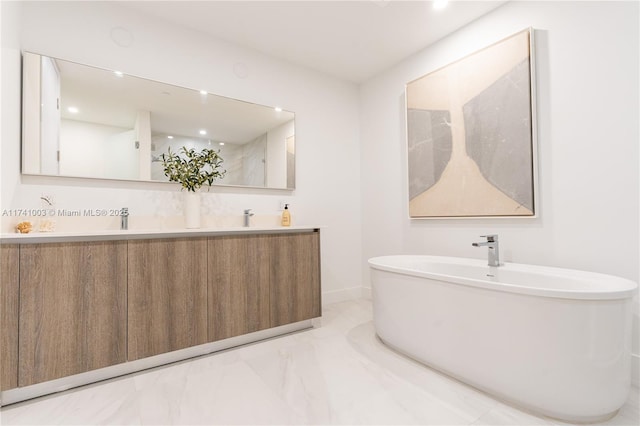 17550 Collins Ave Unit 1501, Sunny Isles Beach, FL 33160 - bathroom with marble finish flooring, a freestanding tub, double vanity, baseboards, and recessed lighting