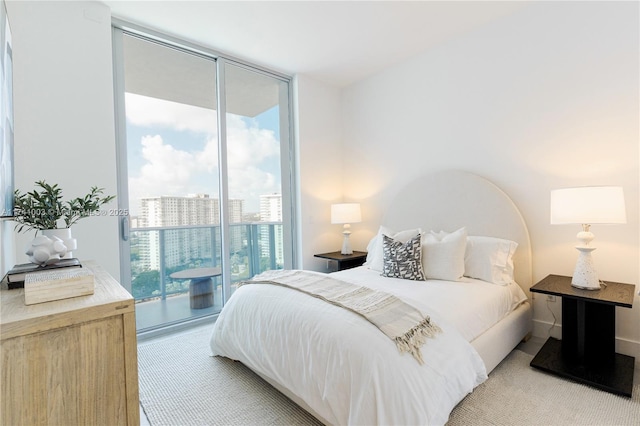 bedroom with floor to ceiling windows and access to outside