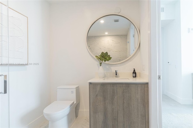 bathroom featuring vanity and toilet