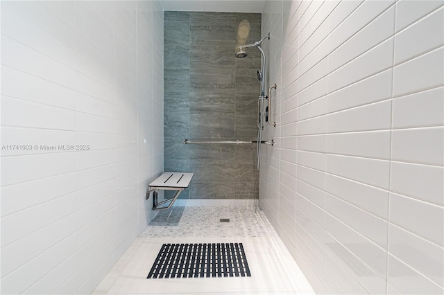 bathroom with tiled shower