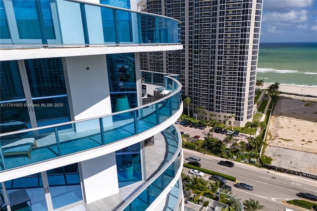 exterior space featuring a water view and a beach view