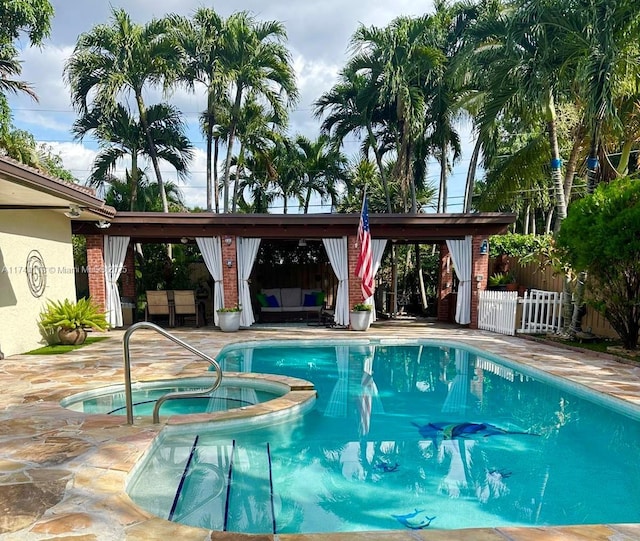 view of swimming pool featuring a patio area and an in ground hot tub