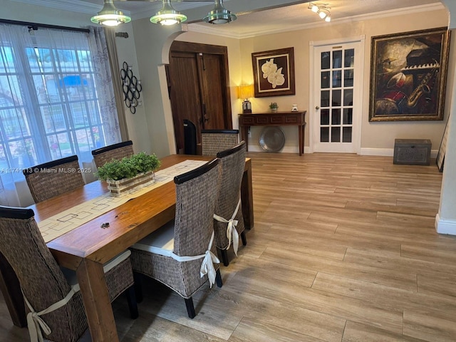 dining room featuring ornamental molding and light wood-type flooring