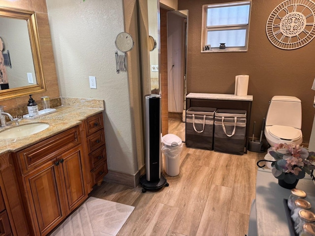 bathroom with vanity, hardwood / wood-style floors, and toilet