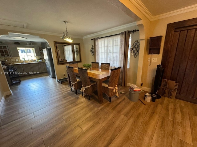 dining area featuring ornamental molding and hardwood / wood-style floors